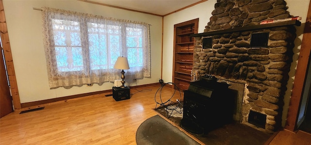 sitting room with hardwood / wood-style flooring and crown molding