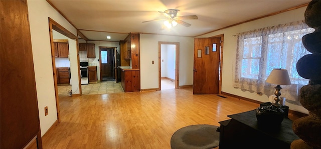 living room with ceiling fan, ornamental molding, and light wood-type flooring