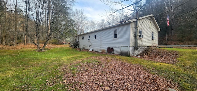 view of property exterior featuring cooling unit and a lawn