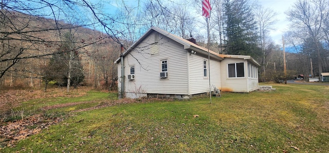 view of side of property with a yard