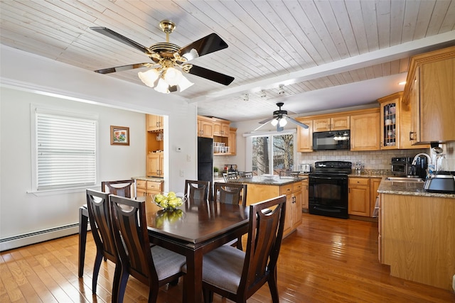 dining space featuring sink, wood ceiling, baseboard heating, beamed ceiling, and light wood-type flooring