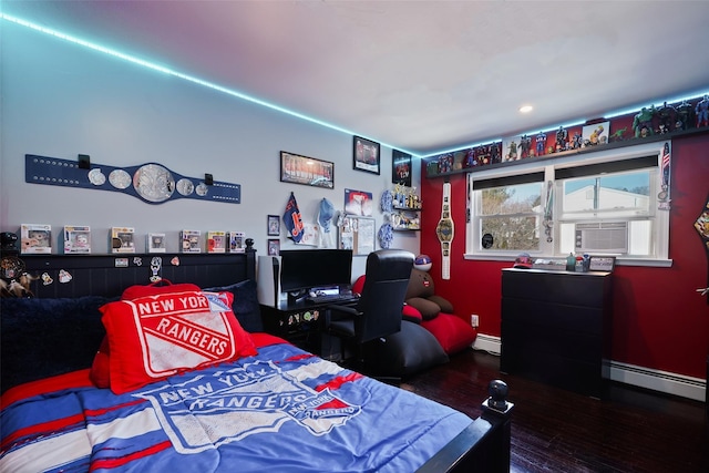 bedroom with a baseboard heating unit, cooling unit, and dark hardwood / wood-style floors