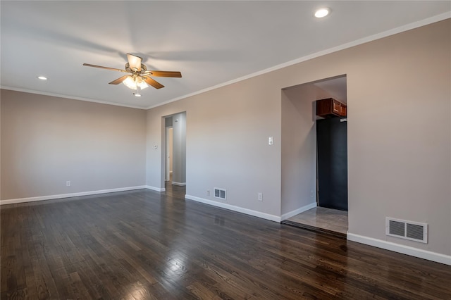 unfurnished room with baseboards, visible vents, and dark wood-style flooring