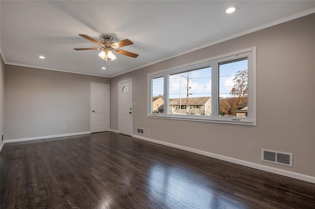 unfurnished room featuring baseboards, visible vents, dark wood-style flooring, and crown molding