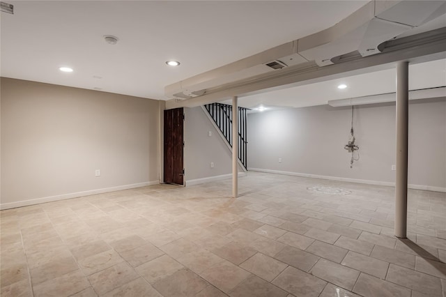 finished below grade area featuring stairway, recessed lighting, visible vents, and baseboards