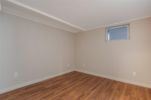 empty room with baseboards and wood finished floors