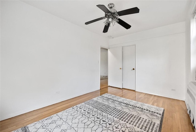 bedroom with ceiling fan and wood-type flooring