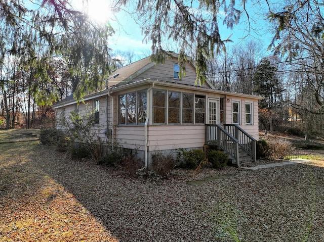 view of side of home featuring a sunroom