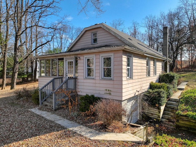 bungalow-style home with a sunroom