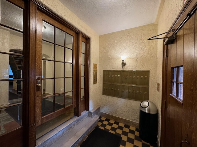 bathroom with a textured ceiling and a mail area