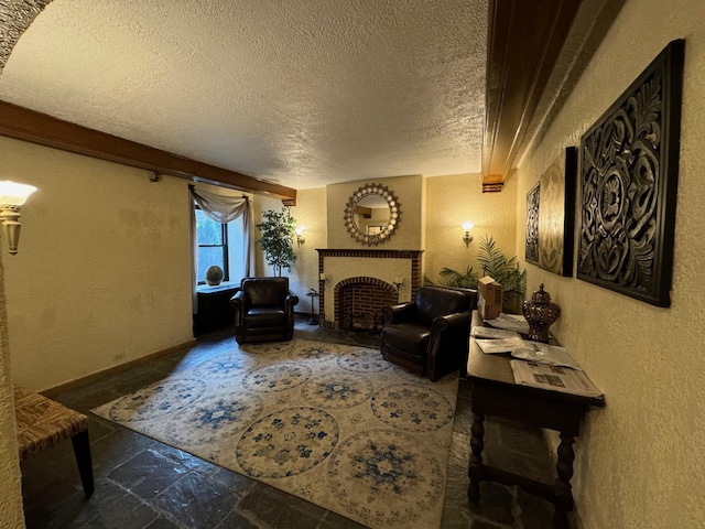 living room with a fireplace and a textured ceiling