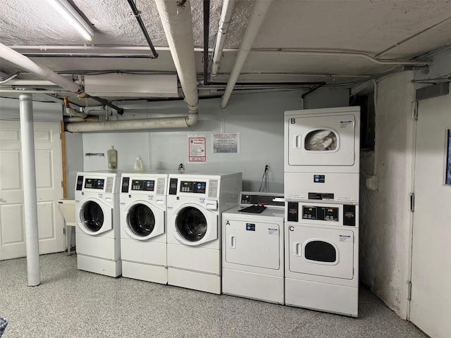 clothes washing area with washing machine and dryer and stacked washing maching and dryer