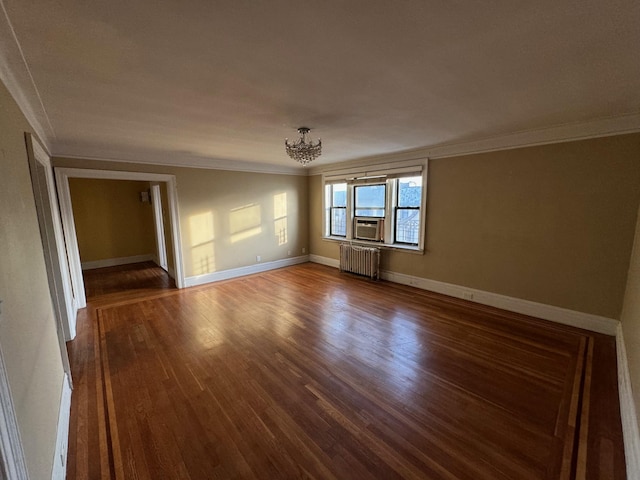 empty room featuring radiator heating unit, hardwood / wood-style flooring, cooling unit, and crown molding