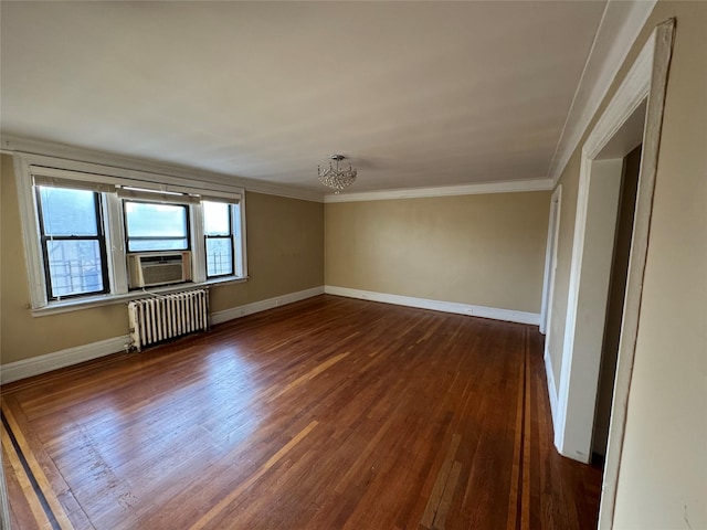 empty room featuring dark hardwood / wood-style flooring, radiator, cooling unit, crown molding, and a chandelier