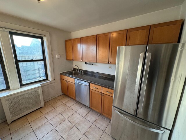 42 Pondfield Rd W Unit 6C, Bronxville, NY 10708 - kitchen with stainless steel appliances, radiator, a sink, and brown cabinets