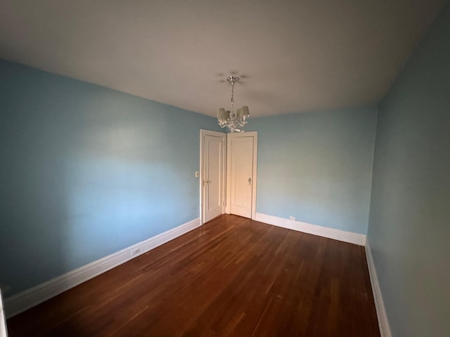 42 Pondfield Rd W Unit 6C, Bronxville, NY 10708 - spare room with dark wood finished floors, baseboards, and a chandelier