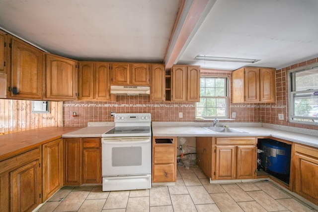 kitchen with beam ceiling, tasteful backsplash, sink, and white electric range