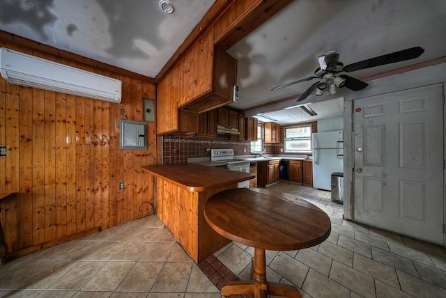 kitchen featuring decorative backsplash, wood walls, white appliances, and kitchen peninsula