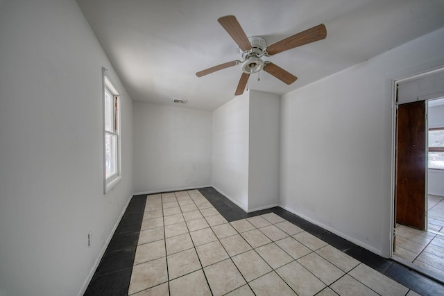 spare room featuring ceiling fan and light tile patterned flooring