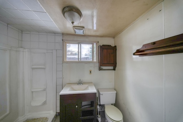 bathroom with vanity, toilet, walk in shower, and crown molding