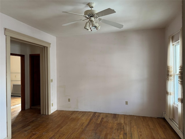 spare room with ceiling fan, dark hardwood / wood-style flooring, and a baseboard heating unit