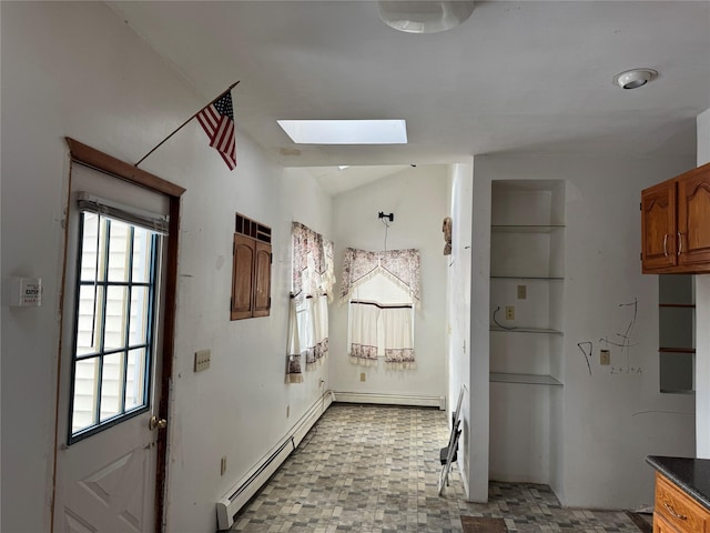 doorway featuring a skylight, built in features, and a baseboard heating unit