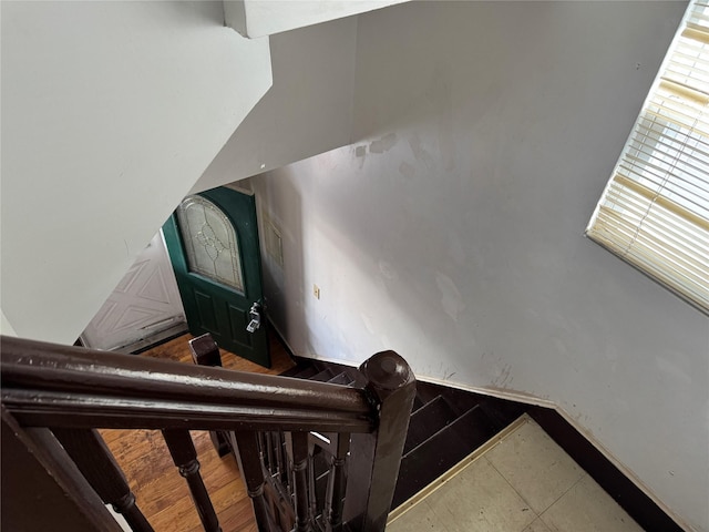 stairway featuring tile patterned flooring