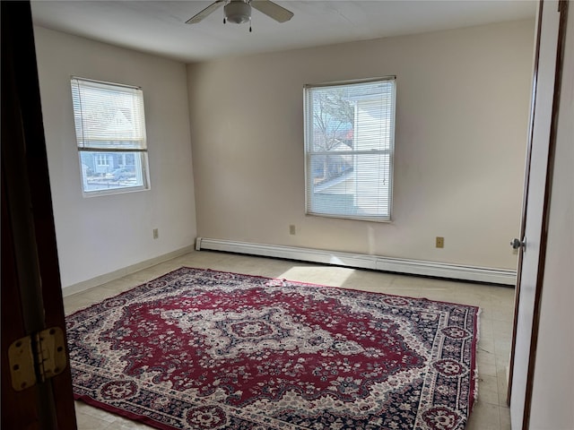 spare room with ceiling fan and baseboard heating