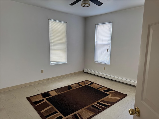 unfurnished room featuring ceiling fan, a healthy amount of sunlight, and baseboard heating