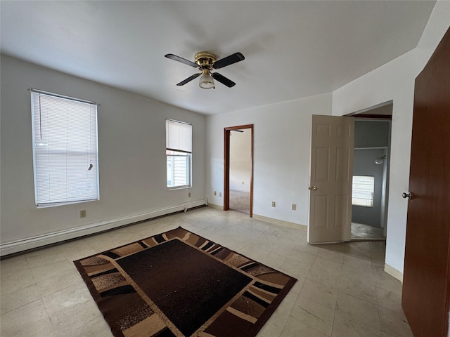 empty room with a baseboard heating unit and ceiling fan