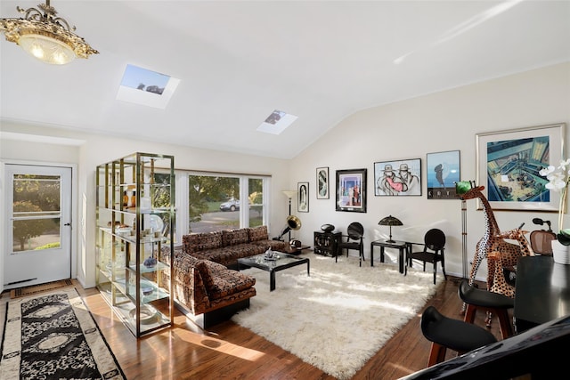 living room with vaulted ceiling with skylight and light hardwood / wood-style flooring