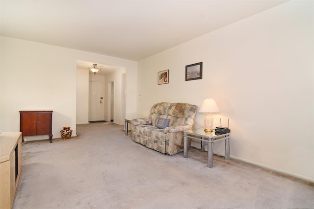 sitting room featuring light carpet