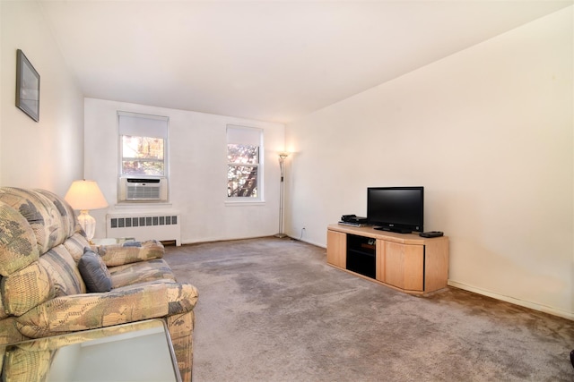 carpeted living room featuring radiator heating unit and cooling unit