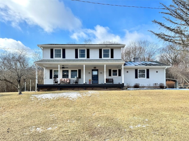 view of front of house with a front yard and a porch