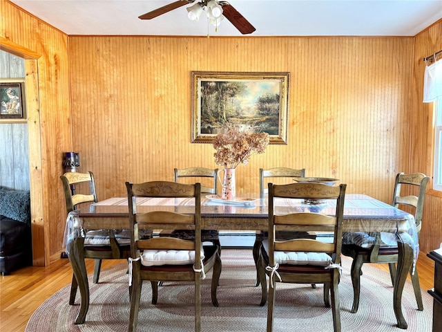 dining area with wood-type flooring and ceiling fan