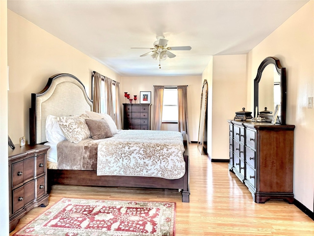 bedroom with light hardwood / wood-style flooring and ceiling fan