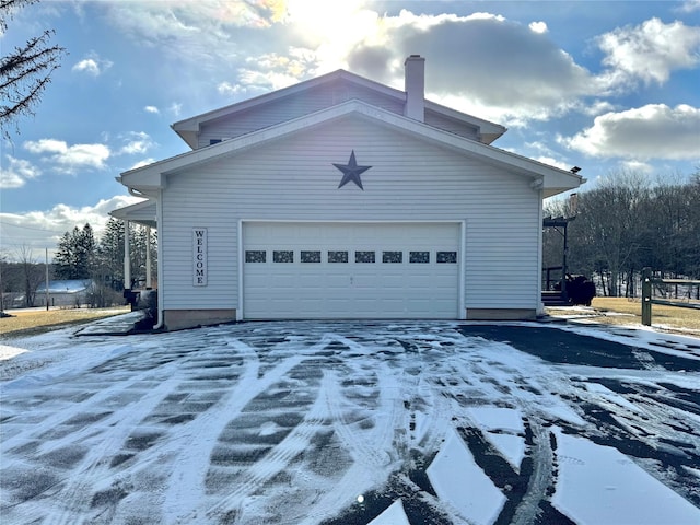 view of snow covered exterior featuring a garage