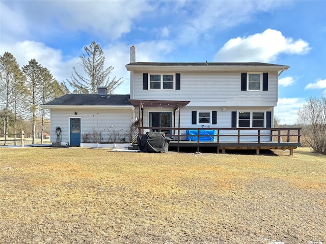 back of house featuring a yard and a deck