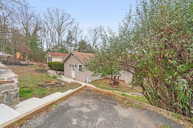 view of front of home featuring an outbuilding