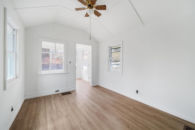 empty room with light hardwood / wood-style floors, ceiling fan, and lofted ceiling