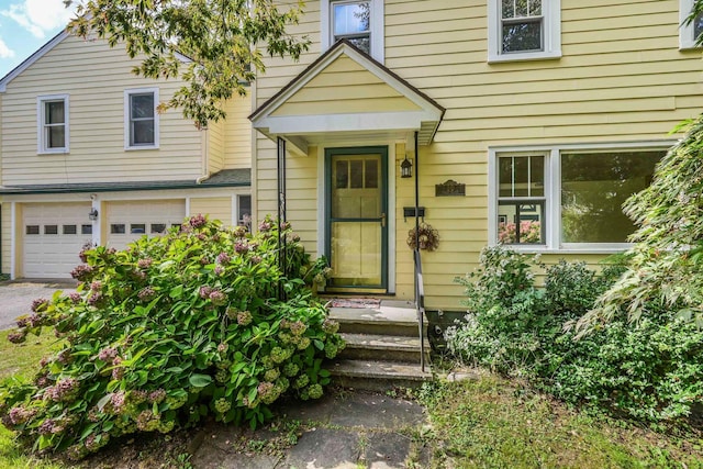 view of exterior entry with a garage