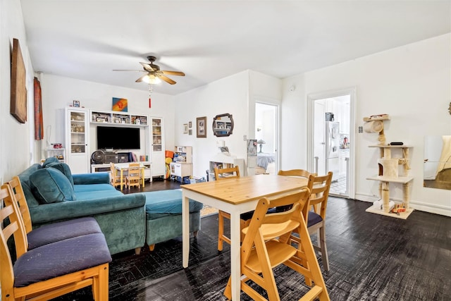 living room with dark hardwood / wood-style flooring and ceiling fan