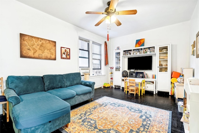 living room with ceiling fan and dark hardwood / wood-style flooring