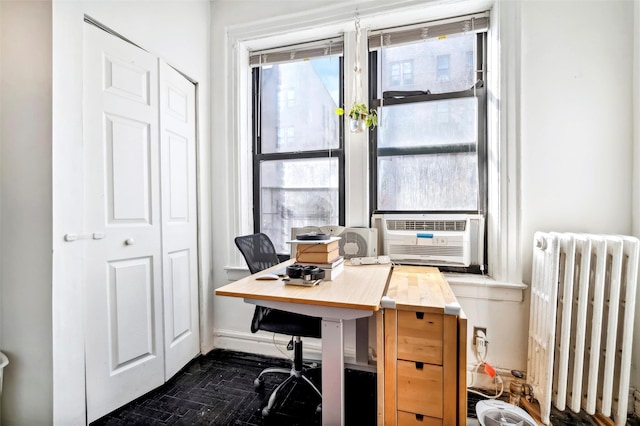 office area featuring radiator heating unit and cooling unit