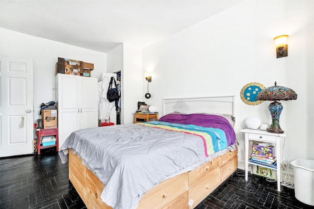 bedroom featuring dark parquet flooring