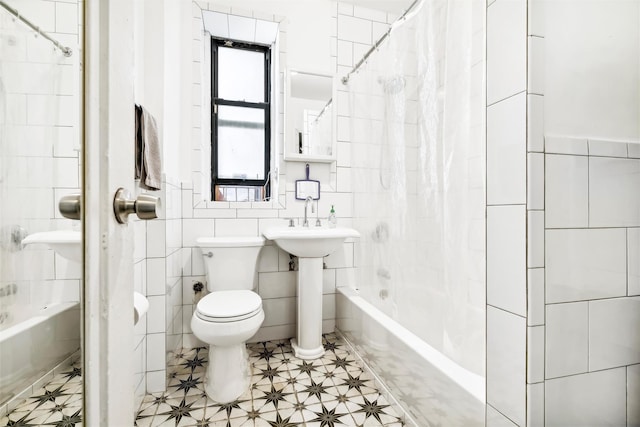 full bathroom featuring shower / bath combo, toilet, tile walls, and sink