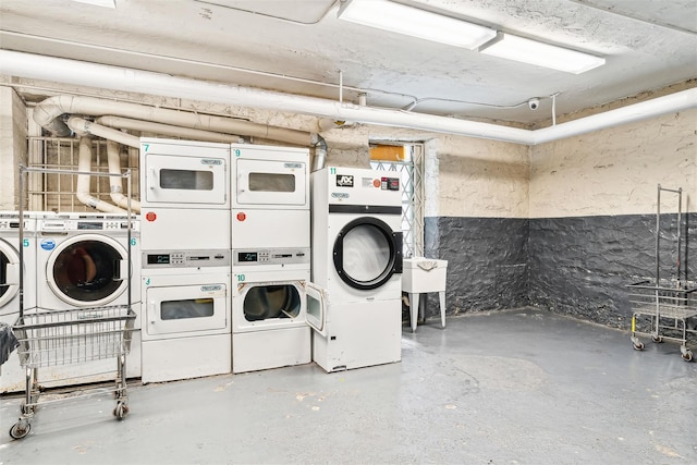 laundry area with washing machine and dryer and stacked washing maching and dryer