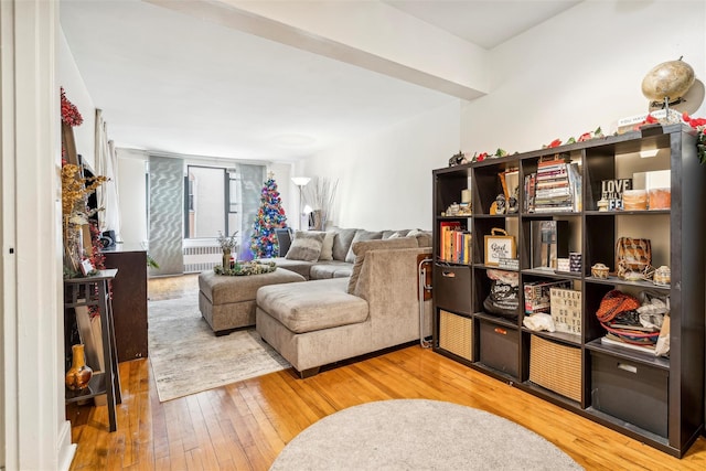 sitting room featuring hardwood / wood-style flooring and radiator heating unit