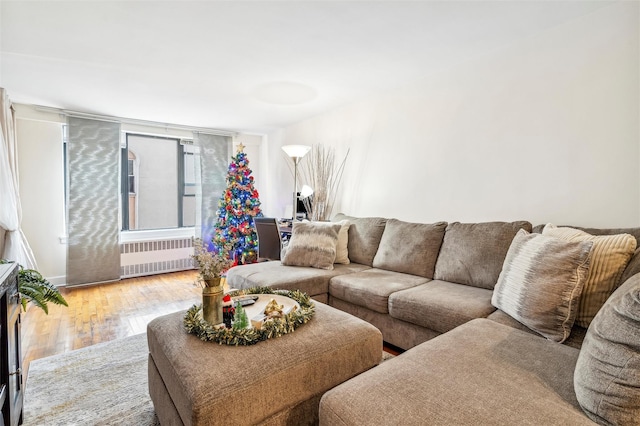 living room with radiator heating unit and hardwood / wood-style floors