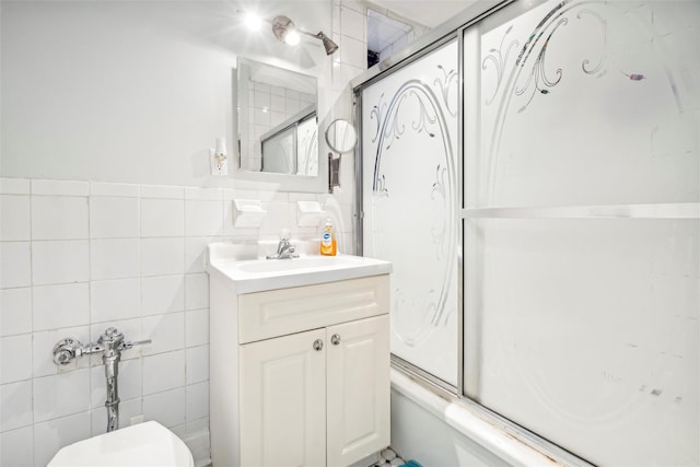 full bathroom featuring vanity, toilet, tile walls, and enclosed tub / shower combo